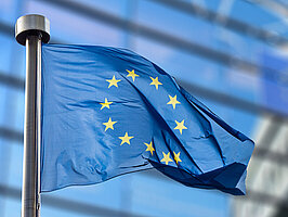 European Union flag against European Parliament