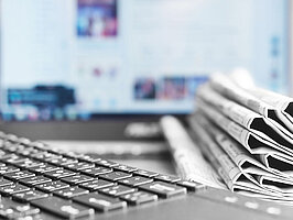 Newspapers and Laptop. Different Concepts for News - Network or Traditional Tabloid Journals. Data Sources - Electronic Screen of Computer or Paper Pages of Magazines, Internet or Papers